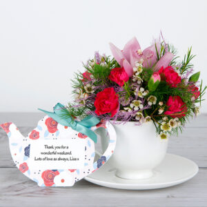 Cymbidium Orchids and Pink Spray Carnations with White Wax Flowers and Green Tree Fern in Bone China Teacup